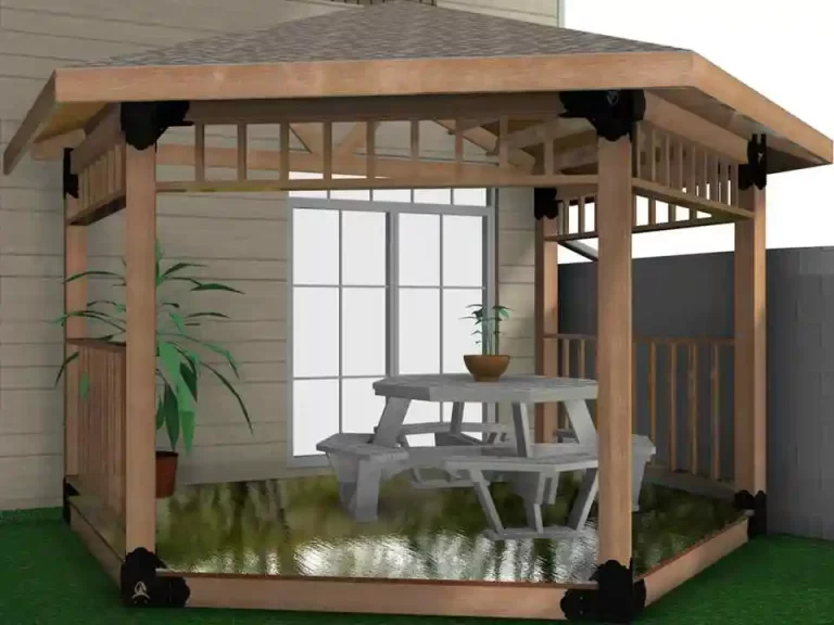 The wooden gazebo features a picnic table and a potted plant, creating a cozy outdoor dining area in a neatly maintained backyard.
