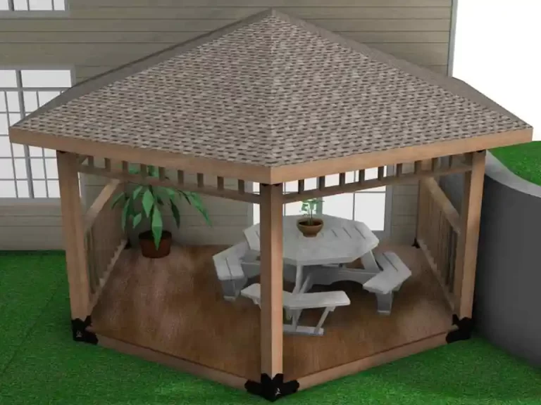 The wooden gazebo features a picnic table and a potted plant, creating a cozy outdoor dining area in a neatly maintained backyard.