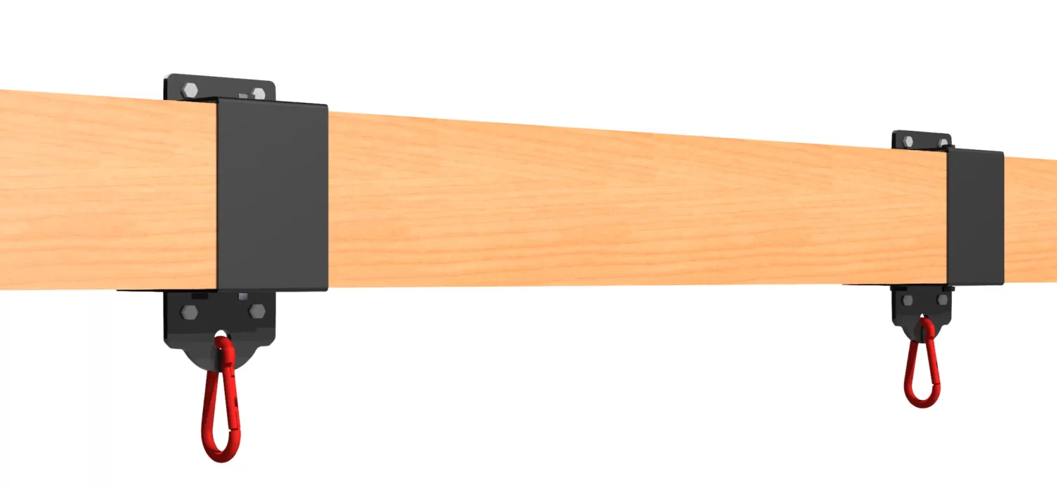 A close-up of a wooden beam with two black 6x6 Swing and Chair Hanger Bracket Kits, each featuring a red hook at the bottom, set against a white background.