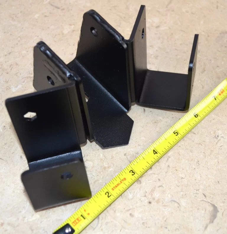 This black metal bracket features a unique design for stable attachment, commonly used in construction projects for holding equipment securely in place