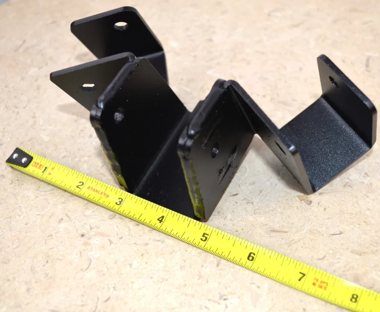 This black metal bracket features a unique design for stable attachment, commonly used in construction projects for holding equipment securely in place