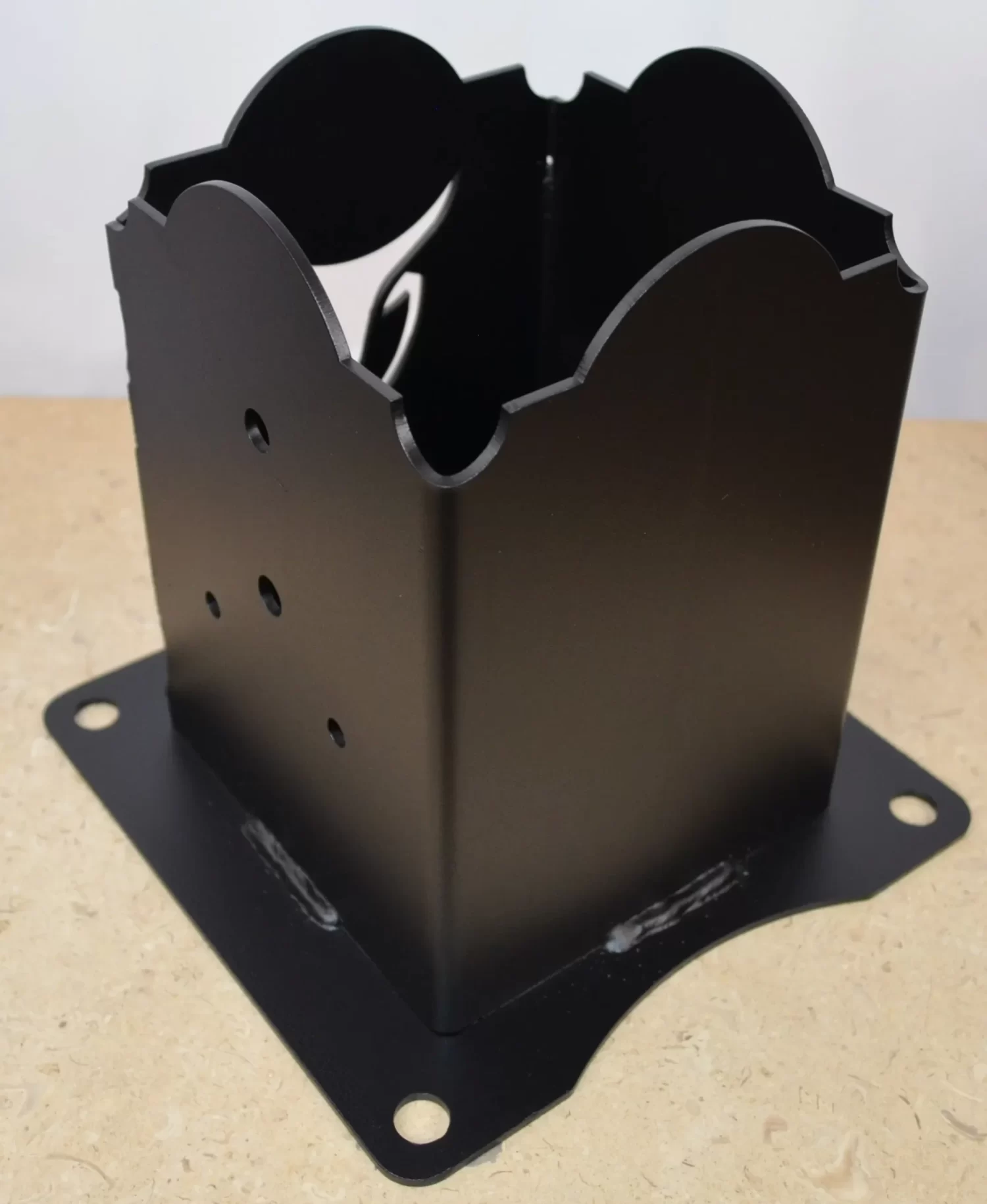 This anchor bracket features a sleek black design with distinct cutouts. Ideal for enhancing construction aesthetics.