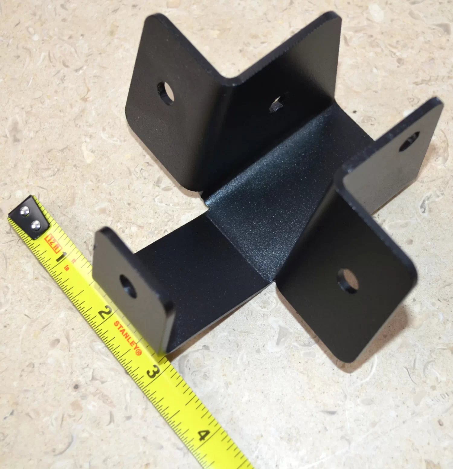 This metal bracket supports various construction applications with secure fastening, ideal for both home repairs and larger building projects requiring reliable stability.