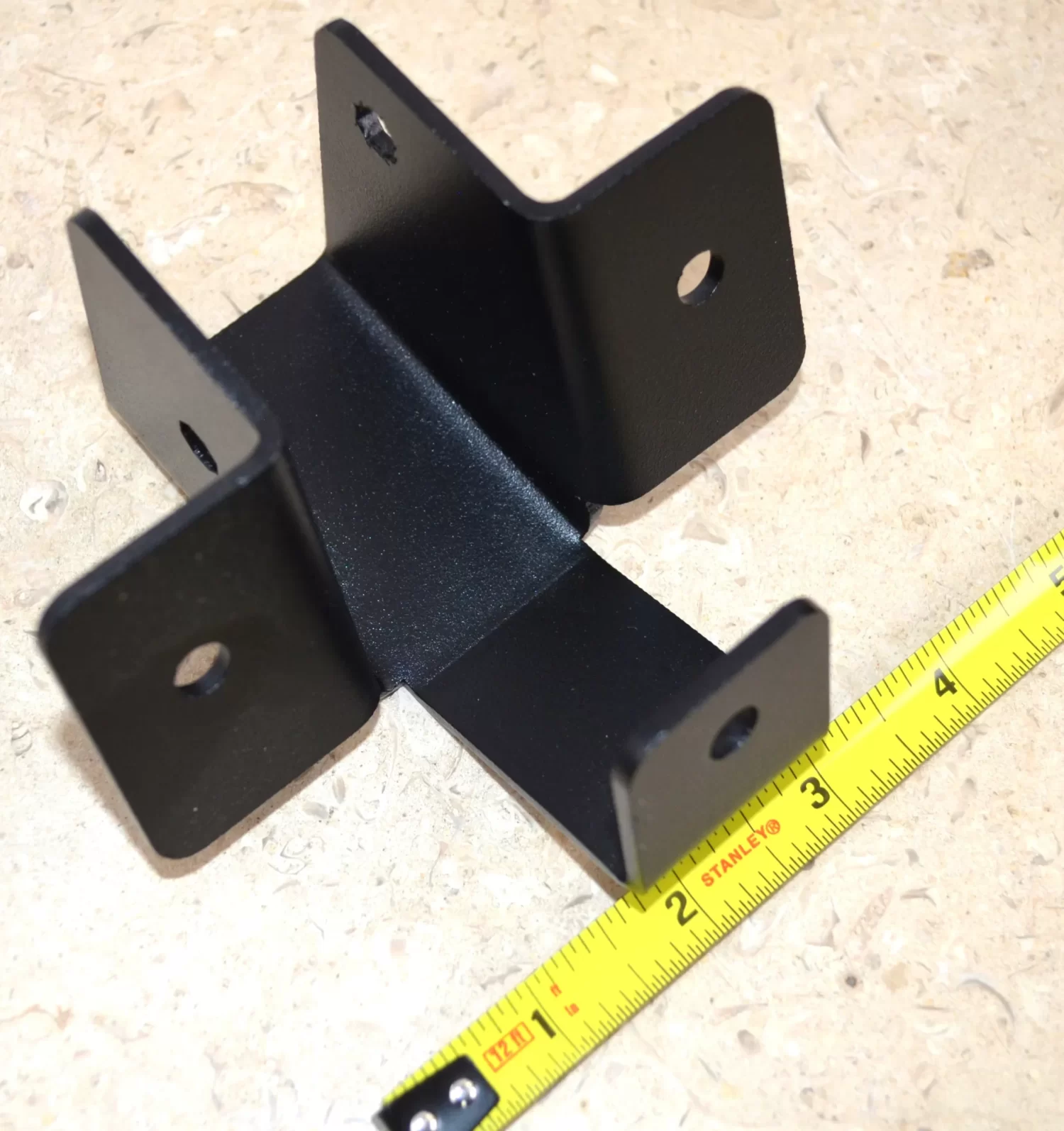 This metal bracket supports various construction applications with secure fastening, ideal for both home repairs and larger building projects requiring reliable stability.