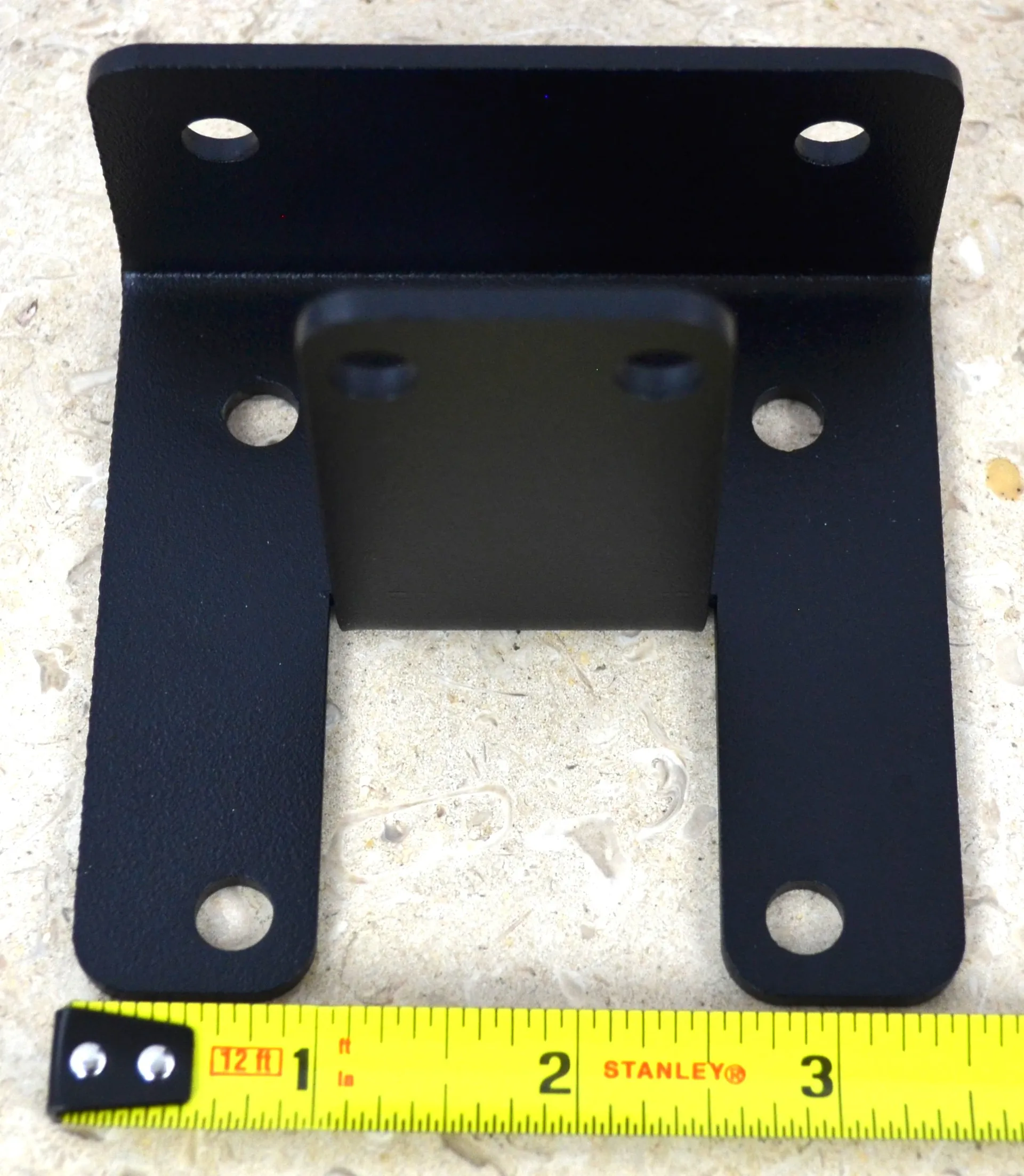 DSC_0136 This black metal open end rafter tie bracket features multiple mounting holes, providing strong support for construction and assembly tasks in various settings.