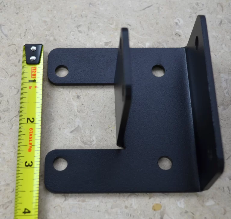 DSC_0139 This black metal open end rafter tie bracket features multiple mounting holes, providing strong support for construction and assembly tasks in various settings.