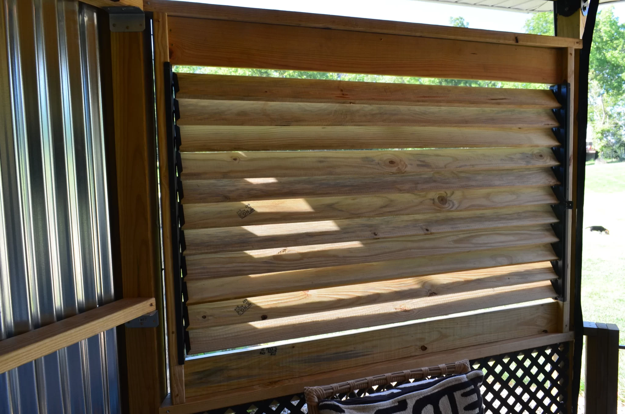 DSC_0107 A wooden deck features stylish slats, enhanced with the Decorative 36 DIY Louver Kit for increased versatility and charm.