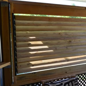 DSC_0107 A wooden deck features stylish slats, enhanced with the Decorative 36 DIY Louver Kit for increased versatility and charm.