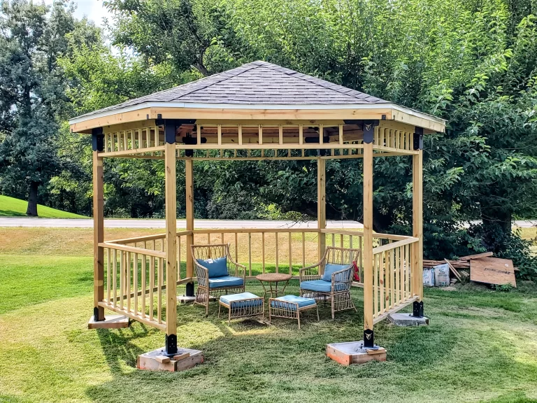 hexagon gazebo on footings with chairs and ottomans