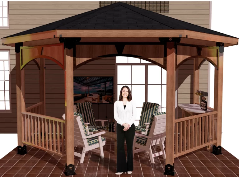 A woman poses elegantly in front of a picturesque RioOutdoors partial octagon gazebo, framed by vibrant foliage and a tranquil setting.