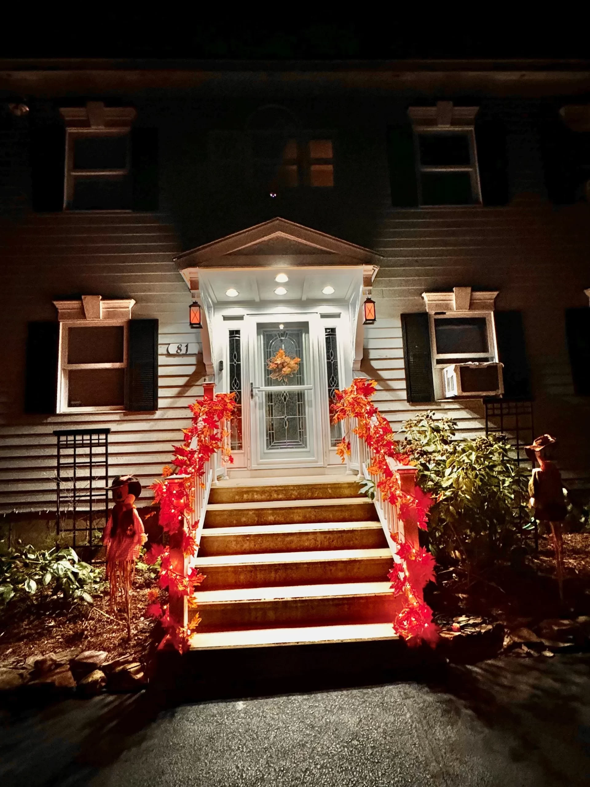 a beautfully decorated front porch with fall colors.